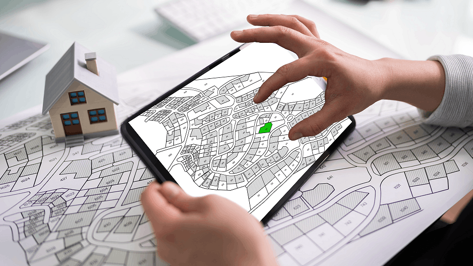 Person on a hand held tablet zooming into a map
