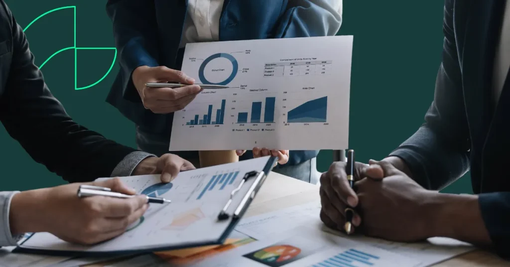 Person presenting some financial figures on a piece on paper showing some charts and graphs